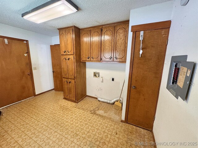 laundry room with cabinet space, a textured ceiling, hookup for a washing machine, light flooring, and hookup for an electric dryer