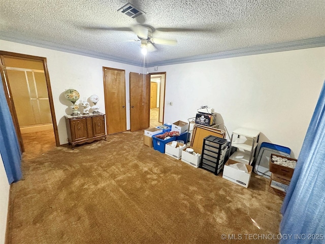 bedroom with ornamental molding, carpet, a textured ceiling, and a ceiling fan