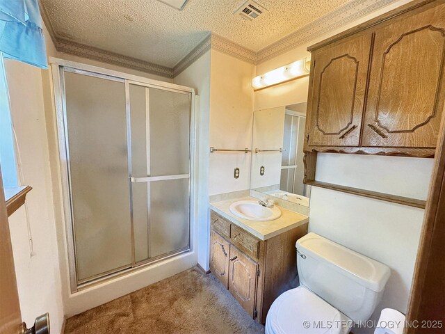 full bathroom featuring a shower stall, vanity, crown molding, toilet, and a textured ceiling