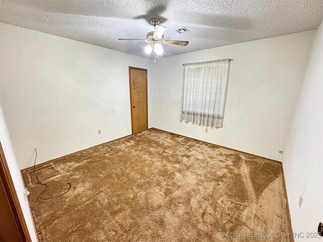 unfurnished room featuring carpet floors, ceiling fan, and a textured ceiling