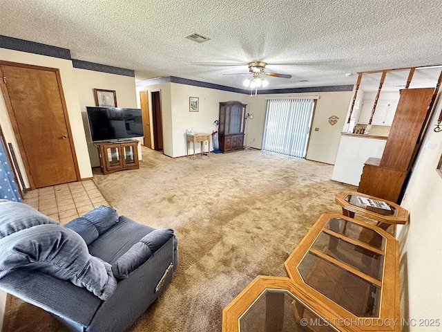 carpeted living room featuring ceiling fan and a textured ceiling
