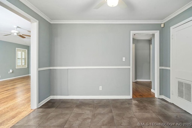 empty room with ceiling fan, baseboards, and crown molding