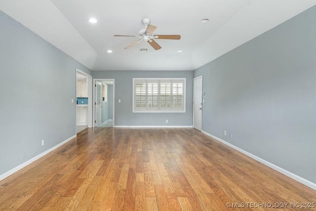 spare room with a ceiling fan, baseboards, wood finished floors, and recessed lighting