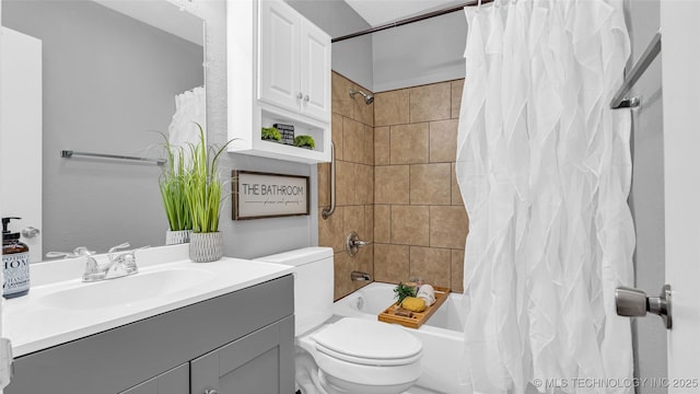 bathroom with toilet, shower / bath combo, and vanity
