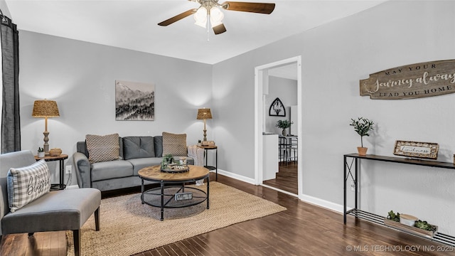 living area with ceiling fan, wood finished floors, and baseboards
