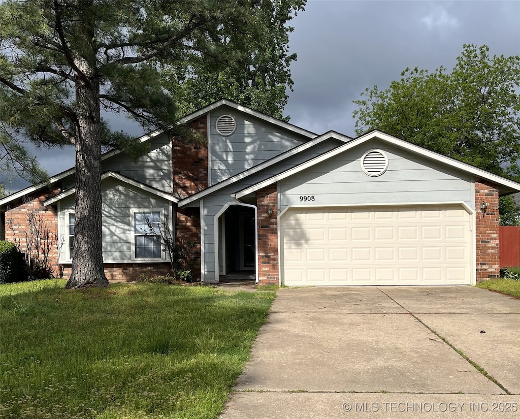view of front of property featuring brick siding, concrete driveway, a garage, and a front yard