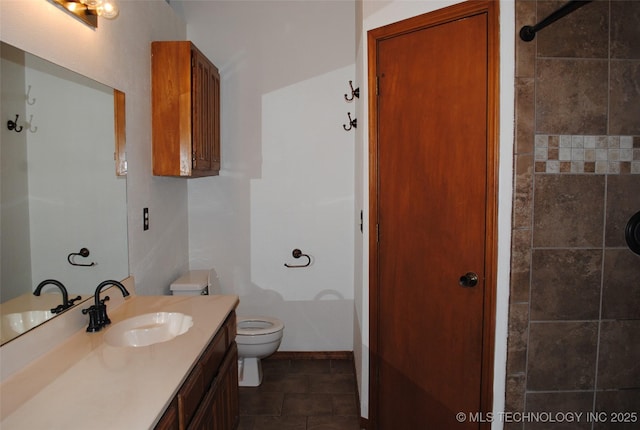 9908 S 95th E Ave, Broken Arrow, OK 74133 - bathroom featuring toilet, vanity, a tile shower, and baseboards