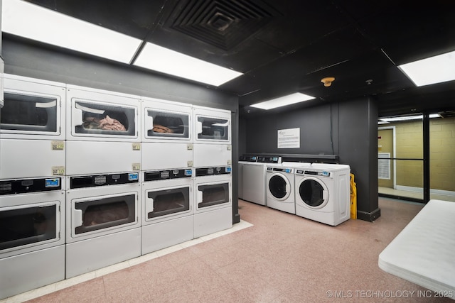 communal laundry room featuring estacked washer and dryer and washer and dryer