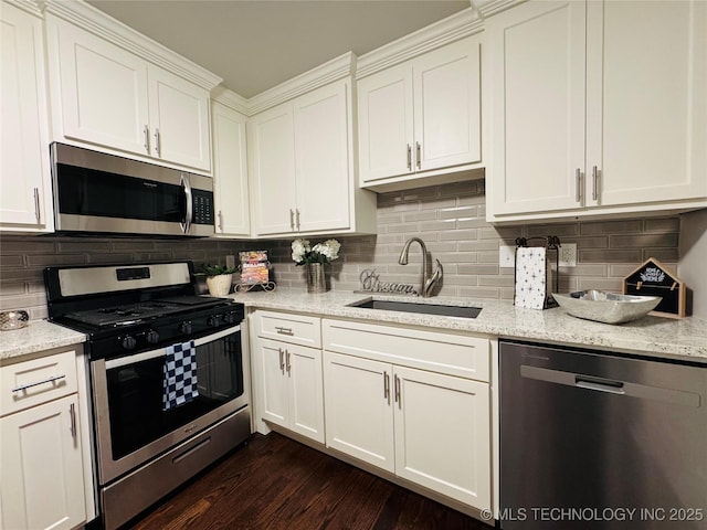 3922 S Norfolk Ave, Tulsa, OK 74105 - kitchen with stainless steel appliances, a sink, white cabinets, dark wood-style flooring, and light stone counters