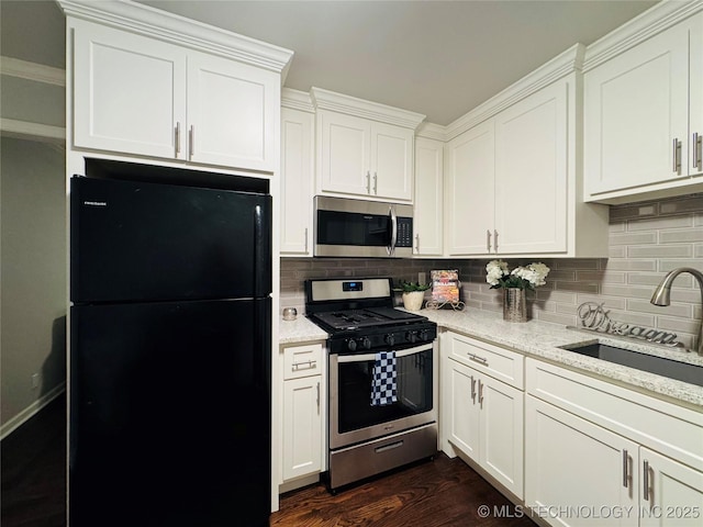 3922 S Norfolk Ave, Tulsa, OK 74105 - kitchen featuring stainless steel appliances, backsplash, white cabinets, and light stone countertops