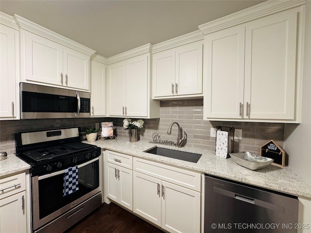 3922 S Norfolk Ave, Tulsa, OK 74105 - kitchen featuring appliances with stainless steel finishes, a sink, white cabinets, and backsplash