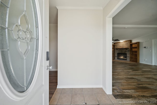 11462 Red Fox Ln, Sperry, OK 74073 - interior space featuring baseboards, a brick fireplace, ornamental molding, and tile patterned flooring