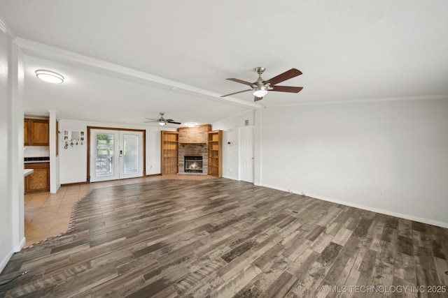 11462 Red Fox Ln, Sperry, OK 74073 - unfurnished living room featuring a fireplace, ceiling fan, wood finished floors, baseboards, and crown molding