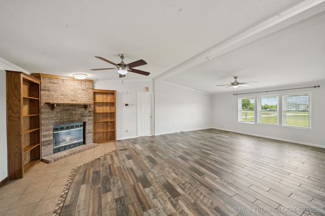 11462 Red Fox Ln, Sperry, OK 74073 - unfurnished living room with ceiling fan, light wood-type flooring, a brick fireplace, baseboards, and ornamental molding