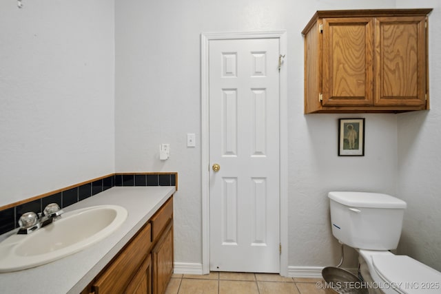 11462 Red Fox Ln, Sperry, OK 74073 - bathroom featuring tile patterned floors, baseboards, toilet, and vanity