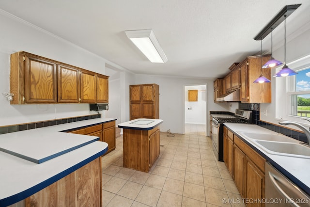 11462 Red Fox Ln, Sperry, OK 74073 - kitchen featuring appliances with stainless steel finishes, a sink, a center island, brown cabinets, and under cabinet range hood