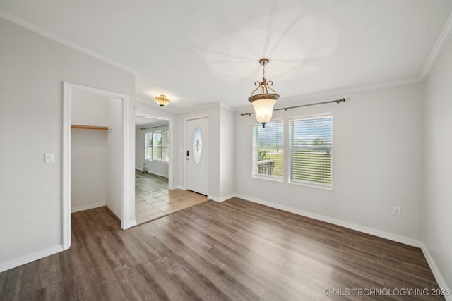 11462 Red Fox Ln, Sperry, OK 74073 - unfurnished dining area featuring wood finished floors, ornamental molding, and baseboards