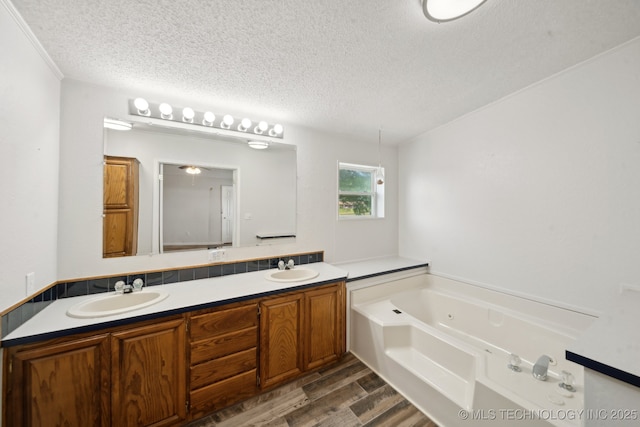 11462 Red Fox Ln, Sperry, OK 74073 - full bath with a textured ceiling, wood finished floors, a whirlpool tub, and double vanity