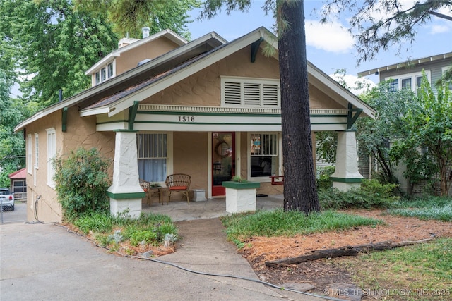 1516 S Elwood Ave, Tulsa, OK 74119 - bungalow-style home featuring a porch and stucco siding