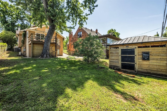 1516 S Elwood Ave, Tulsa, OK 74119 - view of grassy yard featuring stairway, a wooden deck, and an outbuilding