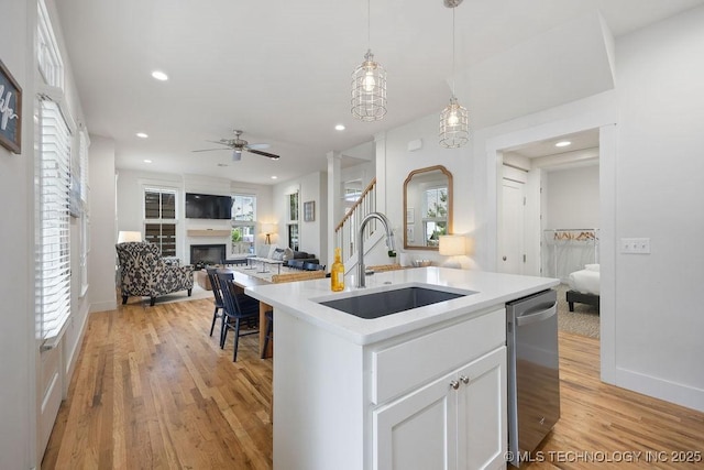 43 Center Ln S, Carlton Landing, OK 74432 - kitchen featuring a sink, light wood-style floors, a fireplace, dishwasher, and recessed lighting