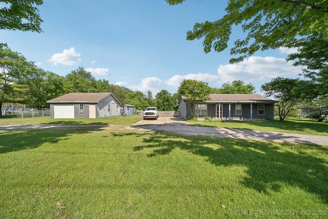 single story home with a garage and an outbuilding