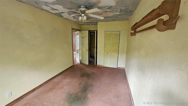 unfurnished bedroom with baseboards, a ceiling fan, a closet, and carpet floors