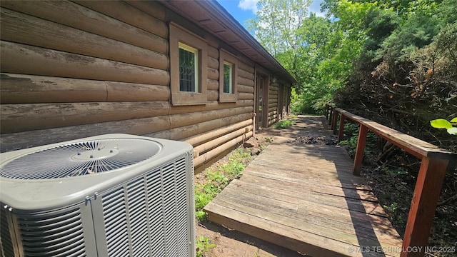 view of side of property with central AC unit and log veneer siding