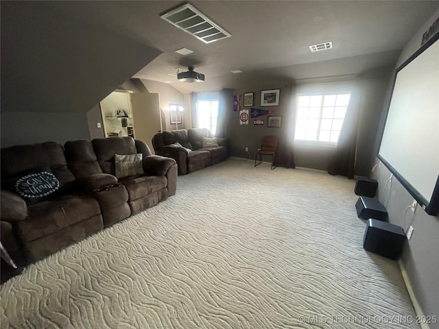 home theater room featuring carpet, plenty of natural light, and vaulted ceiling