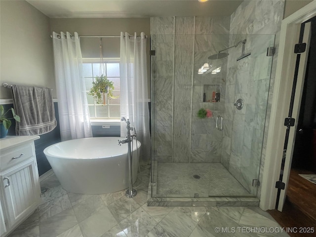 full bathroom with a soaking tub, marble look tiles, and a stall shower