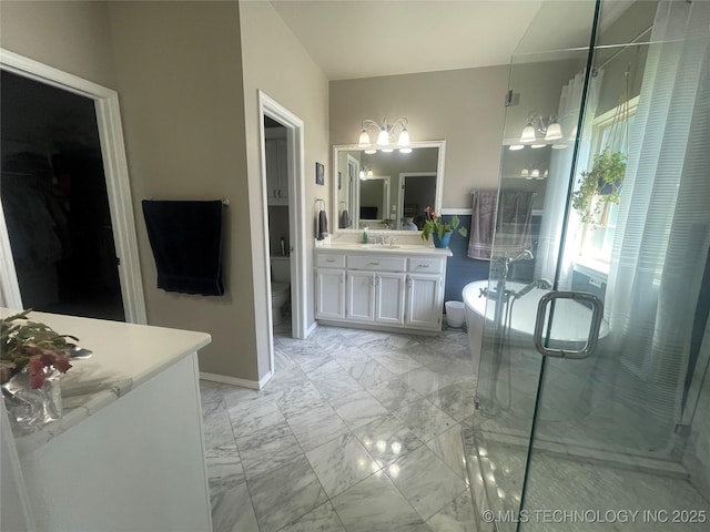 full bathroom featuring toilet, marble look tile flooring, a stall shower, a chandelier, and vanity