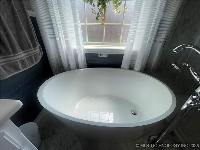 full bath with a freestanding bath