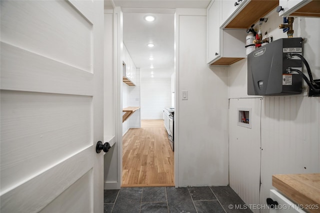 laundry area featuring washer hookup, dark stone finish flooring, and recessed lighting