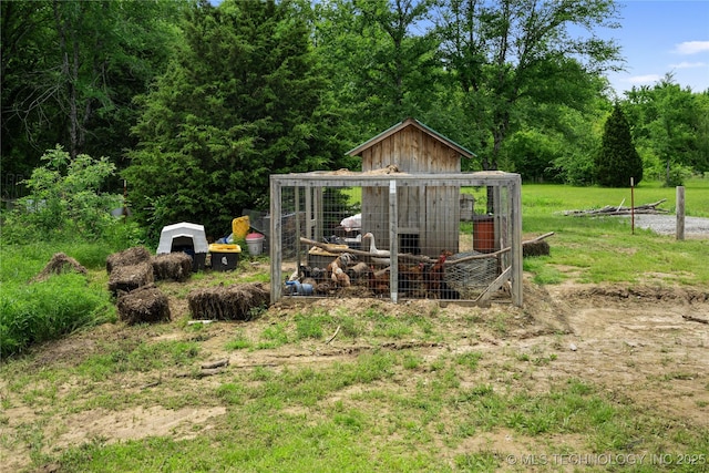 view of poultry coop featuring a view of trees