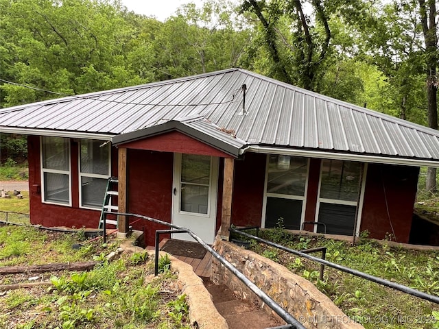 140 Oaks Rd, Eucha, OK 74342 - view of front of house featuring metal roof and a wooded view