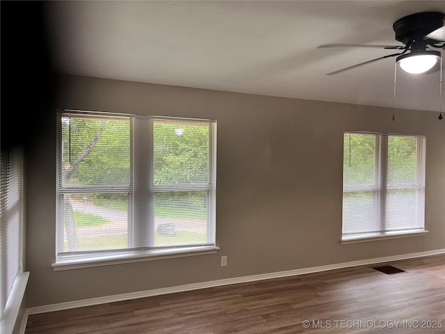140 Oaks Rd, Eucha, OK 74342 - unfurnished room with wood finished floors, ceiling fan, and baseboards
