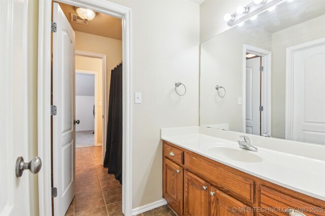 3909 W Utica St, Broken Arrow, OK 74011 - bathroom featuring tile patterned flooring, vanity, and baseboards