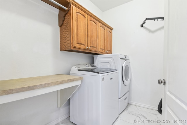 3909 W Utica St, Broken Arrow, OK 74011 - laundry room with light marble finish flooring, cabinet space, washing machine and clothes dryer, and baseboards