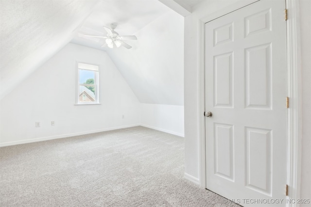 additional living space featuring lofted ceiling, carpet, baseboards, and ceiling fan