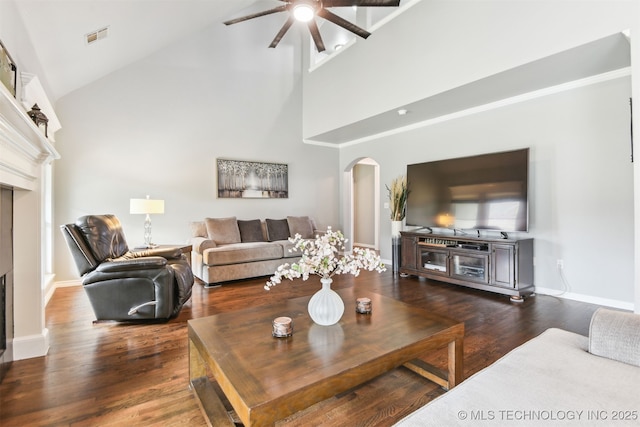 3909 W Utica St, Broken Arrow, OK 74011 - living area featuring arched walkways, a fireplace, ceiling fan, high vaulted ceiling, and dark wood finished floors