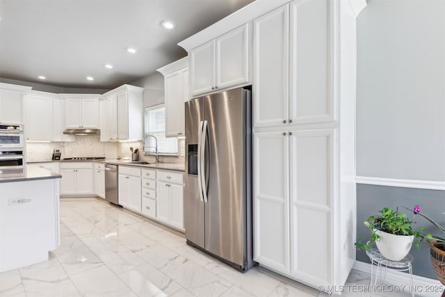 3909 W Utica St, Broken Arrow, OK 74011 - kitchen featuring stainless steel appliances, a sink, recessed lighting, light marble finish flooring, and white cabinets