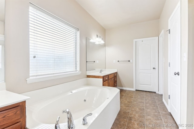 full bath featuring vanity and a jetted tub