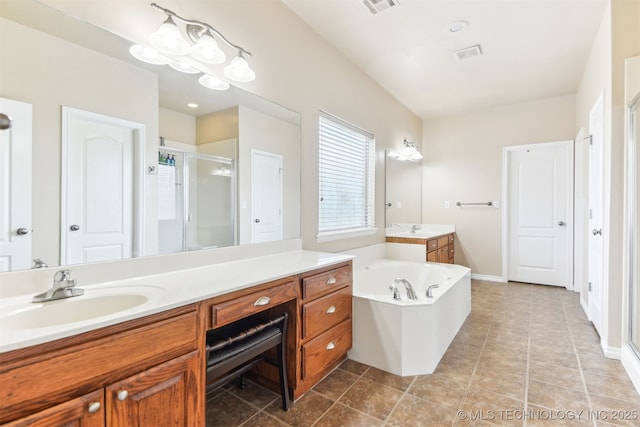 full bathroom featuring a stall shower, vanity, a garden tub, and tile patterned flooring
