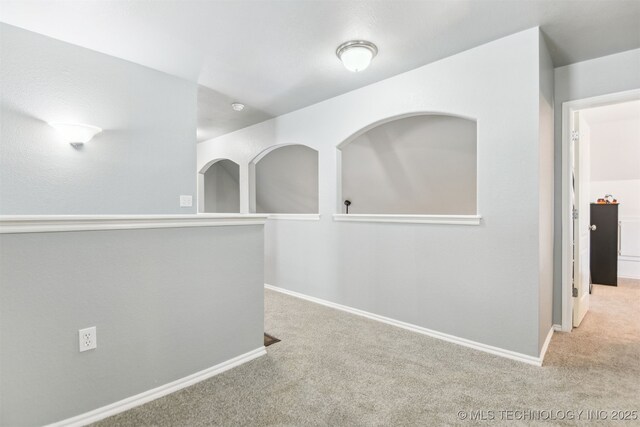 carpeted spare room with baseboards