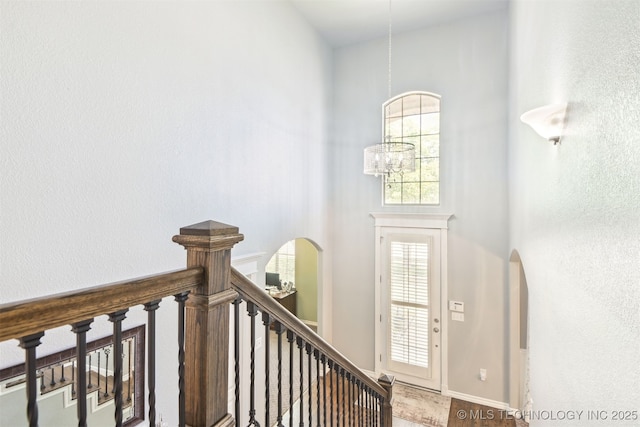 3909 W Utica St, Broken Arrow, OK 74011 - foyer entrance featuring arched walkways, a high ceiling, and a chandelier