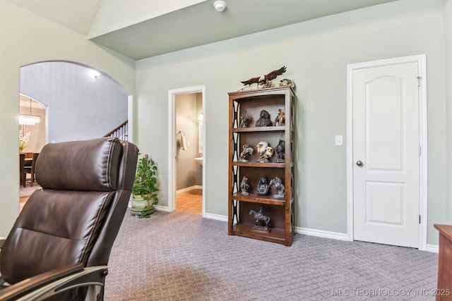 office featuring carpet floors, arched walkways, and baseboards