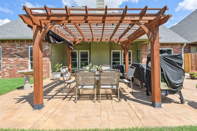 view of patio / terrace with fence, outdoor dining space, and a pergola