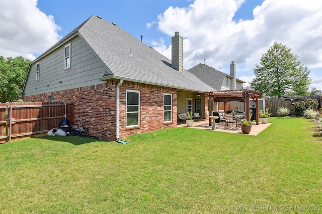 back of house with a chimney, brick siding, a patio area, and a shingled roof