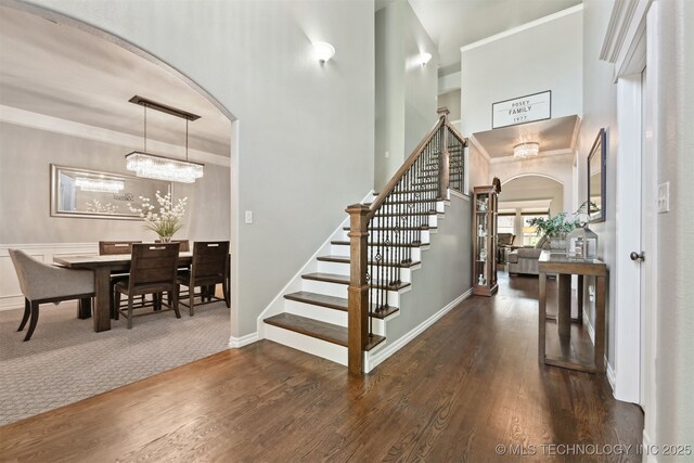 3909 W Utica St, Broken Arrow, OK 74011 - foyer with arched walkways, stairway, wood finished floors, a high ceiling, and crown molding