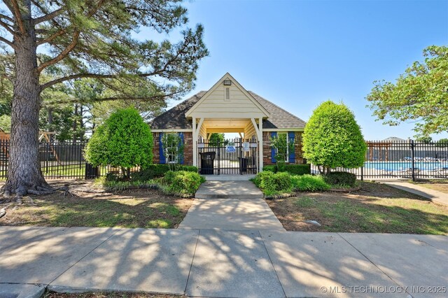 3909 W Utica St, Broken Arrow, OK 74011 - view of property's community with a fenced front yard, a pool, and a gate